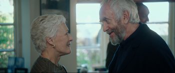 Movie still from “The Wife” (2017), directed by Björn Runge – An older man and a younger woman looking at each other; Close Up shot, Over the shoulder angle