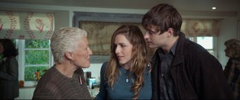Movie still from “The Wife” (2017), directed by Björn Runge – A woman and two young men talking to an older woman; Medium shot, Over the shoulder angle