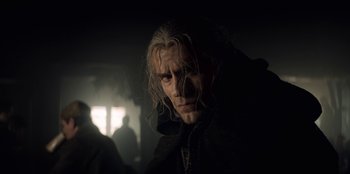 Movie still from “The Witcher” (2019), created by Lauren Schmidt Hissrich – A person with long white hair; Close Up shot, Low angle