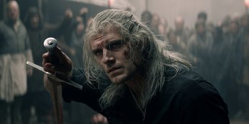 Movie still from “The Witcher” (2019), created by Lauren Schmidt Hissrich – A person holding a knife in his hand; Close Up shot, Over the shoulder angle
