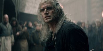 Movie still from “The Witcher” (2019), created by Lauren Schmidt Hissrich – A person with long white hair; Close Up shot, Over the shoulder angle