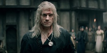 Movie still from “The Witcher” (2019), created by Lauren Schmidt Hissrich – A person wearing a necklace; Close Up shot, Over the shoulder angle