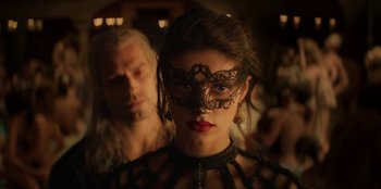 Movie still from “The Witcher” (2019), created by Lauren Schmidt Hissrich – A woman wearing a black mask and a man in a black leather jacket; Close Up shot, Over the shoulder angle