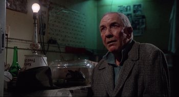Movie still from “Rocky” (1976), directed by John G. Avildsen – An older man is looking at a fish in a bowl; Close Up shot, Low angle