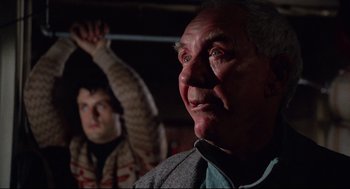 Movie still from “Rocky” (1976), directed by John G. Avildsen – An older man and a younger man in a dark room; Close Up shot, Low angle