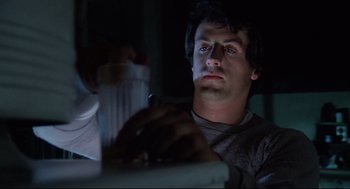 Movie still from “Rocky” (1976), directed by John G. Avildsen – A man sitting in front of a computer at night; Close Up shot, Low angle