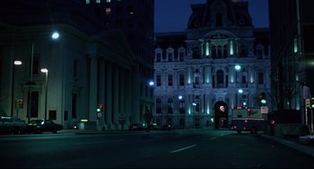 Movie still from “Rocky” (1976), directed by John G. Avildsen – A city street at night lit up by street lights; Extreme Wide shot, High angle