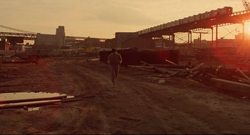 Movie still from “Rocky” (1976), directed by John G. Avildsen – A man is running on a dirt road; Extreme Wide shot, Low angle