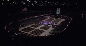 Movie still from “Rocky” (1976), directed by John G. Avildsen – An empty stadium with a large stage in the middle of it; Extreme Wide shot, High angle