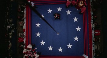 Movie still from “Rocky” (1976), directed by John G. Avildsen – An overhead view of a person sitting on the floor; Extreme Wide shot, Overhead angle
