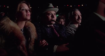 Movie still from “Rocky” (1976), directed by John G. Avildsen – A group of people sitting in front of a crowd; Medium shot, Low angle