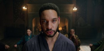 Movie still from “The Witcher” (2019), created by Lauren Schmidt Hissrich – A person with a beard looking at the camera; Close Up shot, Low angle