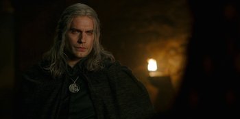 Movie still from “The Witcher” (2019), created by Lauren Schmidt Hissrich – A person wearing a cape; Close Up shot, Over the shoulder angle