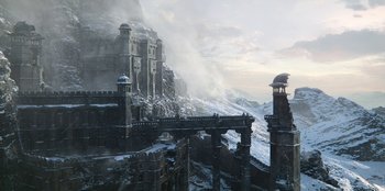 Movie still from “The Witcher” (2019), created by Lauren Schmidt Hissrich – An old castle with a bridge in the middle of it; Extreme Wide shot, High angle