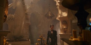 Movie still from “The Witcher” (2019), created by Lauren Schmidt Hissrich – A woman standing in a room filled with candles; Wide shot, Over the shoulder angle