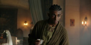 Movie still from “The Witcher” (2019), created by Lauren Schmidt Hissrich – A man with a bowl in his hand; Medium shot, Over the shoulder angle