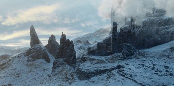 Movie still from “The Witcher” (2019), created by Lauren Schmidt Hissrich – An image of a mountain with a castle in the middle of it; Extreme Wide shot, High angle