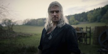 Movie still from “The Witcher” (2019), created by Lauren Schmidt Hissrich – A person with long white hair; Medium shot, Over the shoulder angle