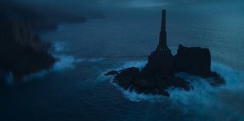 Movie still from “The Witcher” (2019), created by Lauren Schmidt Hissrich – A lighthouse on a rock in the middle of the ocean at night; Extreme Wide shot, High angle