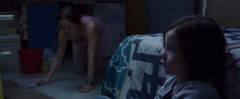 Movie still from “Room” (2015), directed by Lenny Abrahamson – A woman and a child in a dark room; Medium shot, Over the shoulder angle
