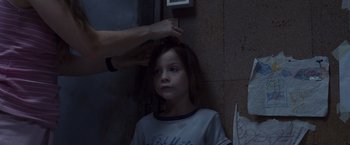 Movie still from “Room” (2015), directed by Lenny Abrahamson – A person is combing a young girl's hair; Close Up shot, Over the shoulder angle