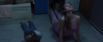 Movie still from “Room” (2015), directed by Lenny Abrahamson – A woman laying on the ground in a living room; Medium shot, Overhead angle