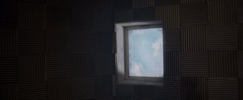 Movie still from “Room” (2015), directed by Lenny Abrahamson – A room with a window that has a sky in it; Extreme Close Up shot, Overhead angle