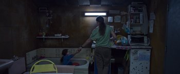 Movie still from “Room” (2015), directed by Lenny Abrahamson – A woman and a child in a room with a sink; Medium shot, High angle