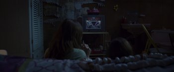 Movie still from “Room” (2015), directed by Lenny Abrahamson – Two people sitting in front of a television; Wide shot, High angle