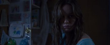 Movie still from “Room” (2015), directed by Lenny Abrahamson – A woman with long hair is looking at the camera; Close Up shot, Over the shoulder angle