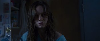 Movie still from “Room” (2015), directed by Lenny Abrahamson – A woman with long brown hair stares into the camera; Close Up shot, Over the shoulder angle