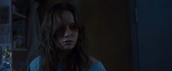 Movie still from “Room” (2015), directed by Lenny Abrahamson – A woman with long brown hair stares into the camera; Close Up shot, Over the shoulder angle