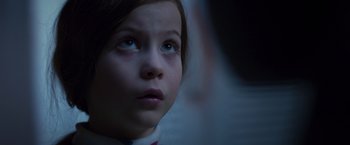 Movie still from “Room” (2015), directed by Lenny Abrahamson – A young girl's face in the dark; Close Up shot, Over the shoulder angle