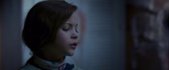 Movie still from “Room” (2015), directed by Lenny Abrahamson – A young girl with her eyes closed and her head turned to the side; Close Up shot, Low angle