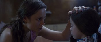 Movie still from “Room” (2015), directed by Lenny Abrahamson – A woman looking into a mirror while holding a mirror; Close Up shot, Over the shoulder angle