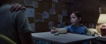 Movie still from “Room” (2015), directed by Lenny Abrahamson – A child sitting at a table with a bowl of food; Medium shot, Over the shoulder angle