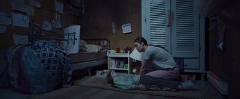 Movie still from “Room” (2015), directed by Lenny Abrahamson – A woman and a child are laying on the floor; Wide shot, High angle
