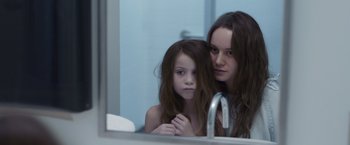 Movie still from “Room” (2015), directed by Lenny Abrahamson – A woman and a young girl looking in a bathroom mirror; Close Up shot, Over the shoulder angle