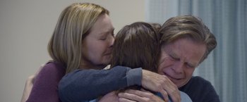 Movie still from “Room” (2015), directed by Lenny Abrahamson – Three people hugging each other in a room; Close Up shot, Overhead angle