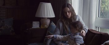 Movie still from “Room” (2015), directed by Lenny Abrahamson – A woman sitting on a couch with a child; Medium shot, High angle
