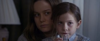 Movie still from “Room” (2015), directed by Lenny Abrahamson – A woman and a girl holding a glass of water; Close Up shot, Over the shoulder angle