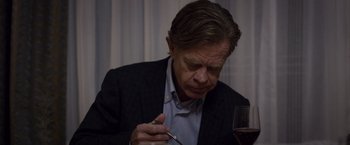 Movie still from “Room” (2015), directed by Lenny Abrahamson – A person sitting at a table with a glass of wine; Close Up shot, High angle