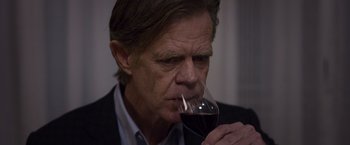 Movie still from “Room” (2015), directed by Lenny Abrahamson – A person holding a glass of red wine; Close Up shot, High angle