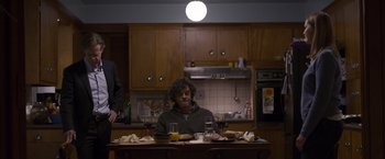 Movie still from “Room” (2015), directed by Lenny Abrahamson – A man sitting at a table with food in front of him; Medium shot, Over the shoulder angle
