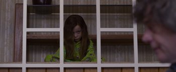 Movie still from “Room” (2015), directed by Lenny Abrahamson – A young girl looking out of a window; Medium shot, High angle