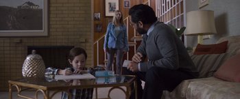 Movie still from “Room” (2015), directed by Lenny Abrahamson – A man and a woman are sitting at a table with a child; Medium shot, Over the shoulder angle