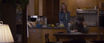 Movie still from “Room” (2015), directed by Lenny Abrahamson – A woman standing at a kitchen counter in front of a bowl of vegetables; Medium shot, Over the shoulder angle