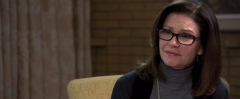 Movie still from “Room” (2015), directed by Lenny Abrahamson – A woman sitting on a couch wearing glasses; Close Up shot, Over the shoulder angle