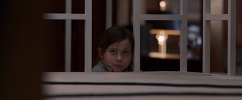 Movie still from “Room” (2015), directed by Lenny Abrahamson – A young girl looking out of a window at night; Close Up shot, High angle