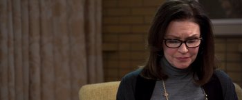 Movie still from “Room” (2015), directed by Lenny Abrahamson – A woman sitting on a couch wearing glasses and a sweater; Close Up shot, Over the shoulder angle